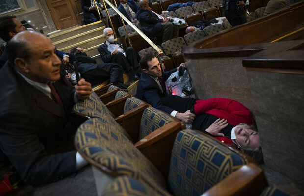 Lawmakers in dramatic photo of Capitol siege recount scene
